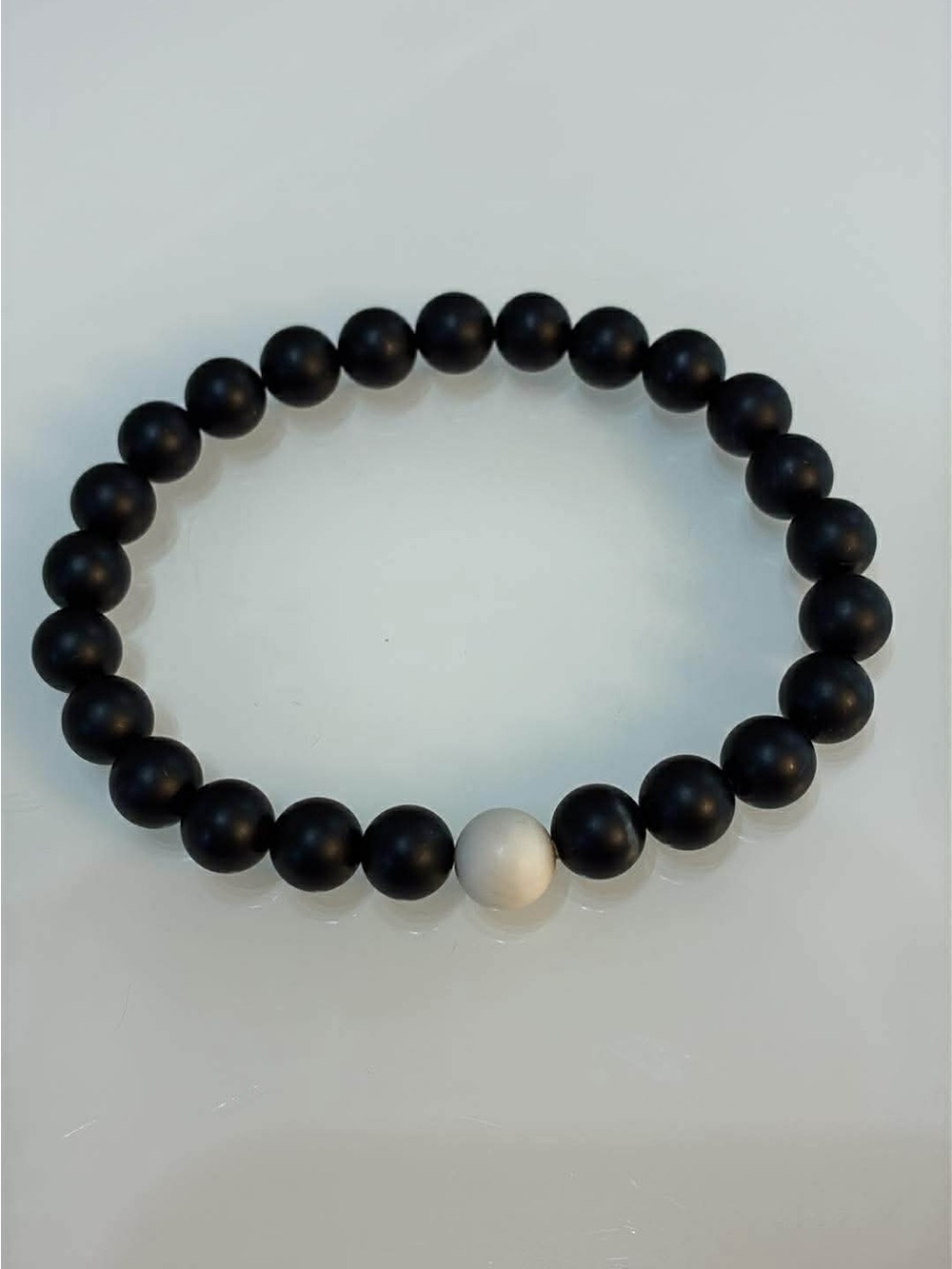 Matte Black Beaded Bracelet with Single White Accent